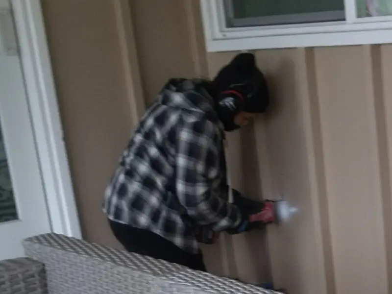 Professional electrician installing an exterior outlet in Evans
