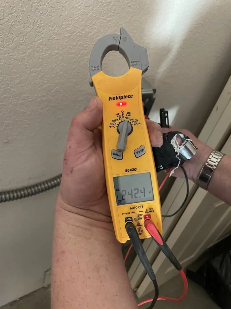 Voltage testing with clamp meter during Ceiling Fan Installation in Evans